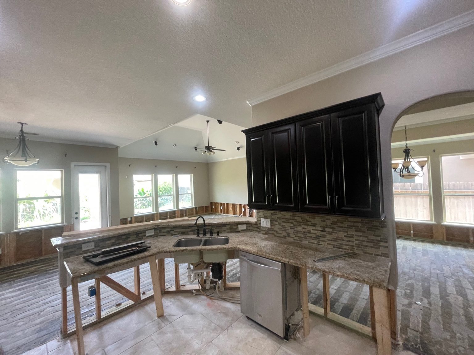 Kitchen water damage demo with cabinets and countertop